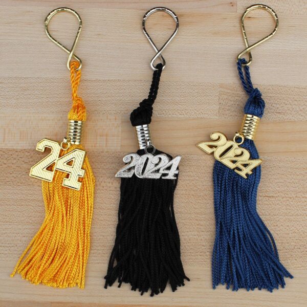 tassel keychains shown in gold, black, and navy