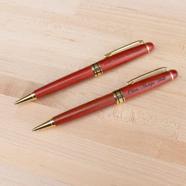 two personalized rosewood pens showing different font options for laser engraving